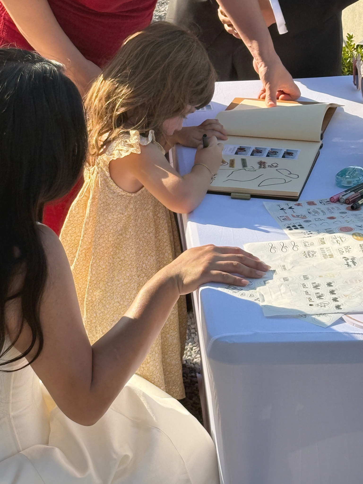 Event guests pasting live photo prints