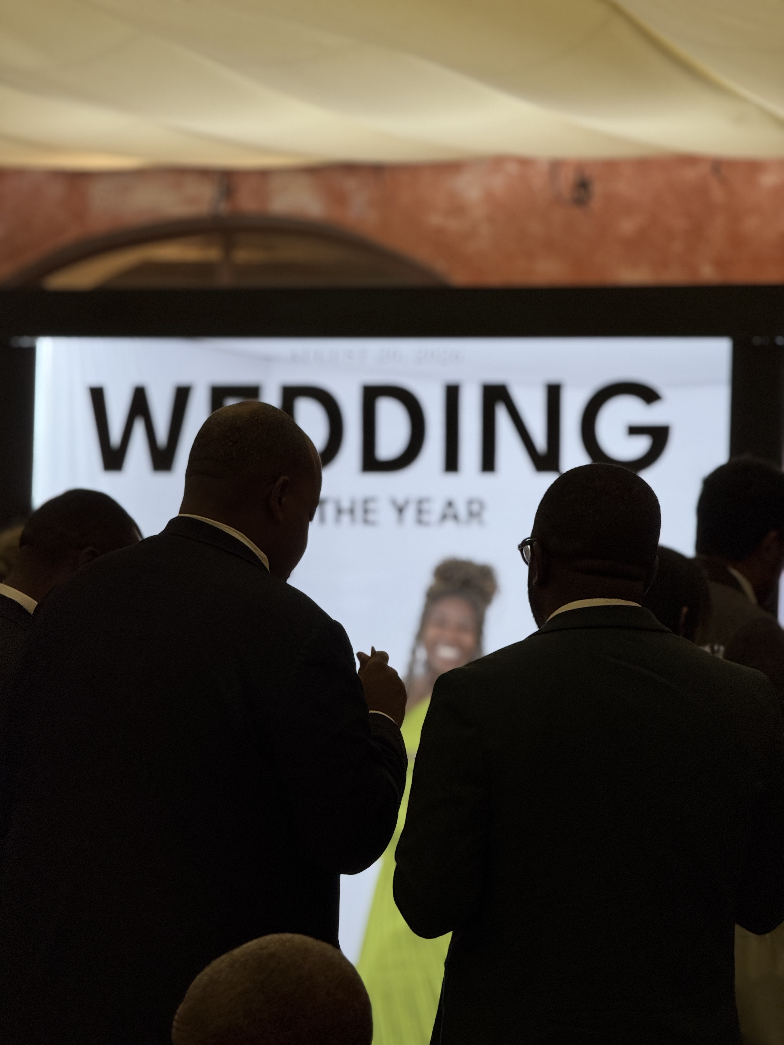 Guests mingling around photo experience in an Italian villa courtyard